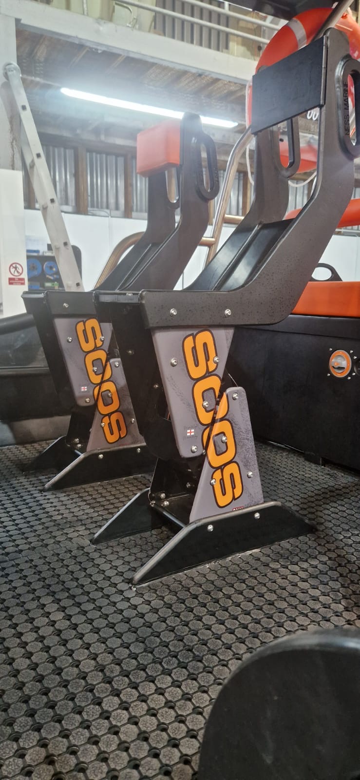 Bucket seats with orange branding installed inside a NESS Marine workboat